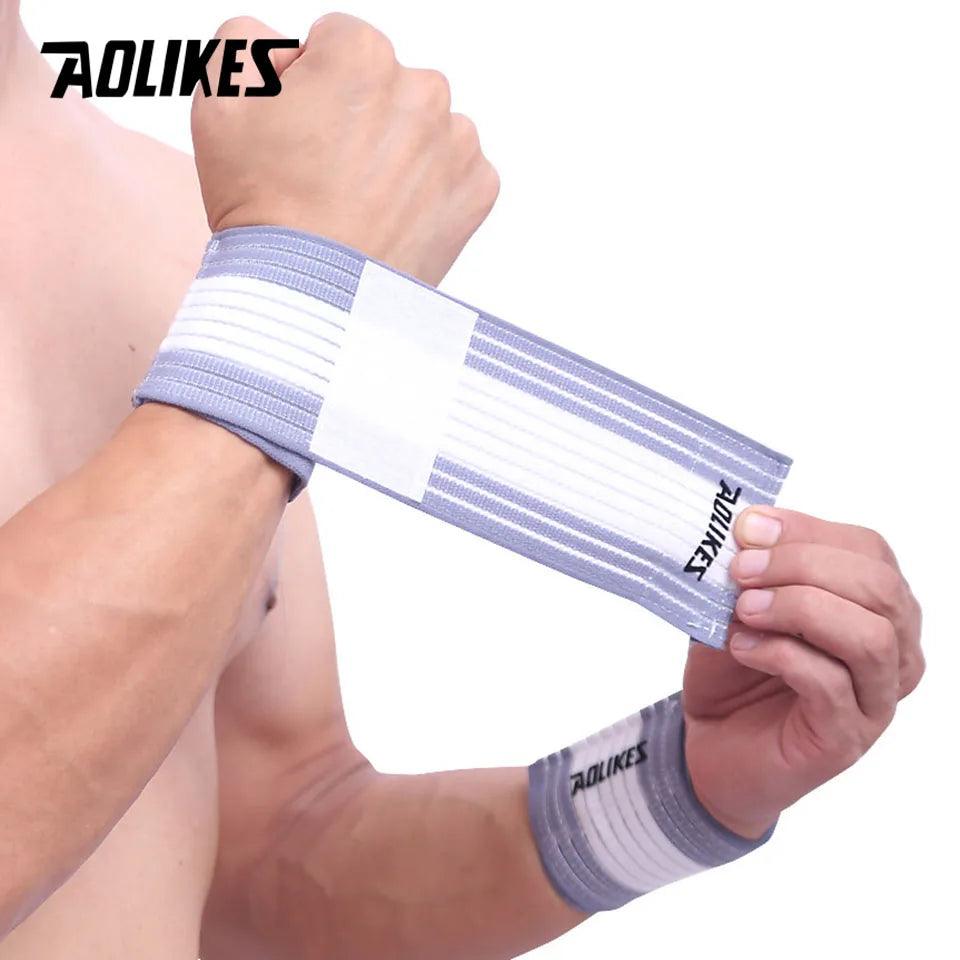 A person wearing an AOLIKES cotton elastic wristband support for sports and wrist protection.