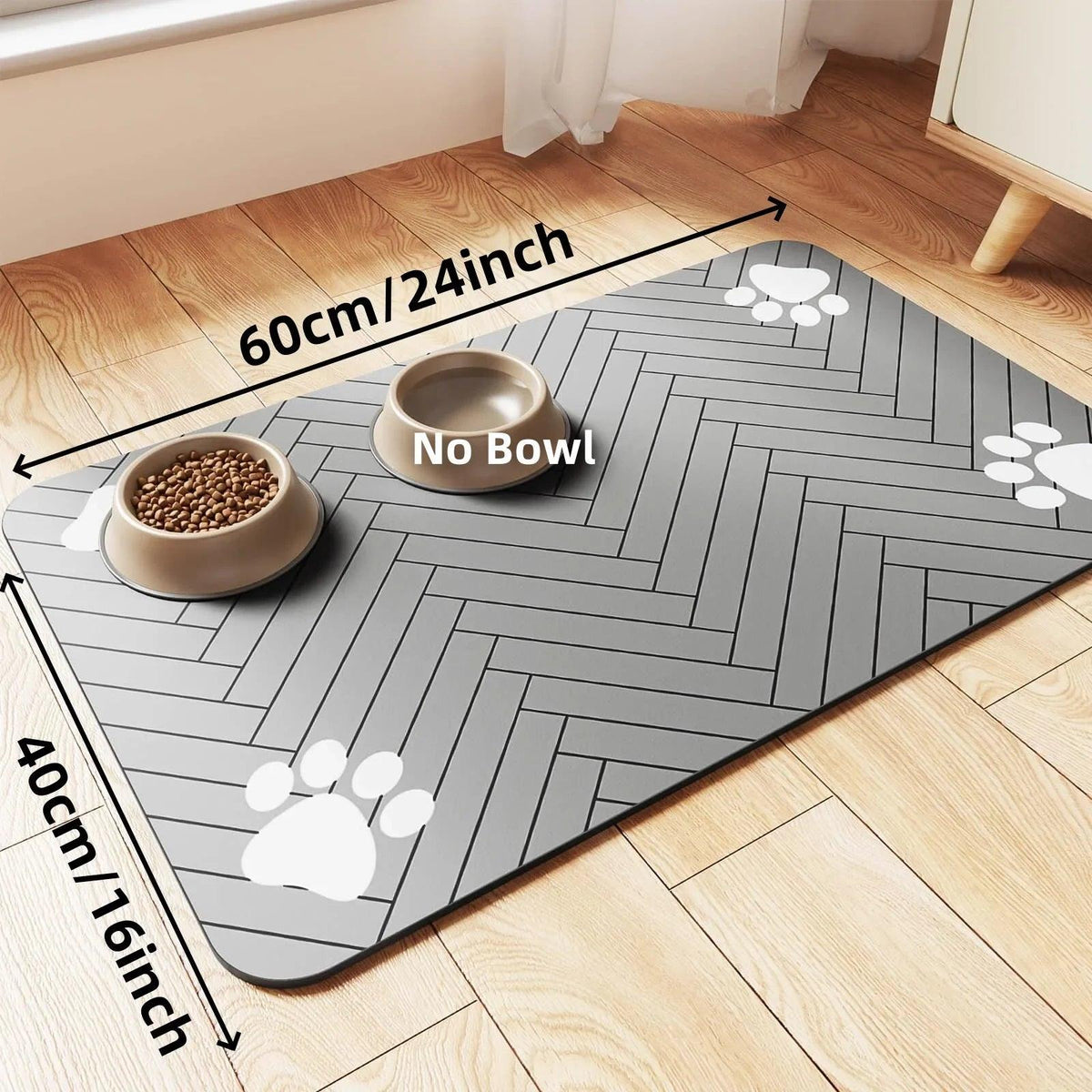 Grey waterproof absorbent pet feeding mat with paw prints and dog bowls on a wood floor.