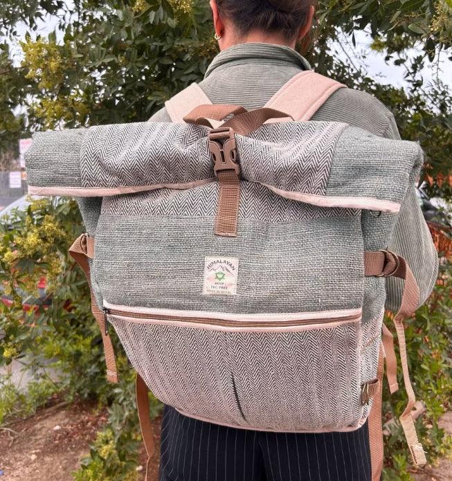 Person wearing a HomesshopUK hemp trekking rolling backpack with a grey herringbone pattern.