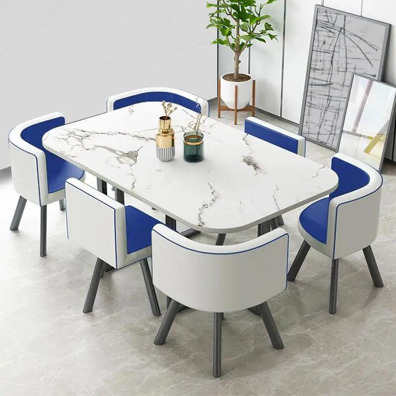 Rectangular marble effect dining table with six blue and white modern dining chairs.